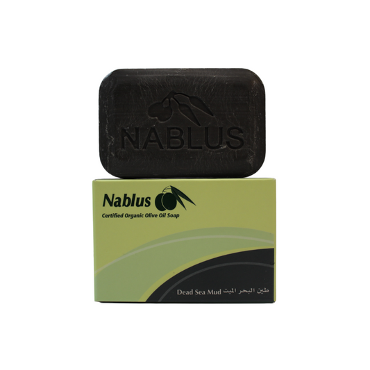 dead sea mud bar made by nablus soap company standing on its packaging