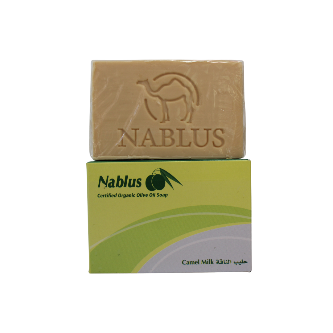 Camel milk and olive oil soap made by nablus soap company with its packaging and the soap is standing on top of it, the packaging ready nablus certified organic olive oil soap and the blend camel milk